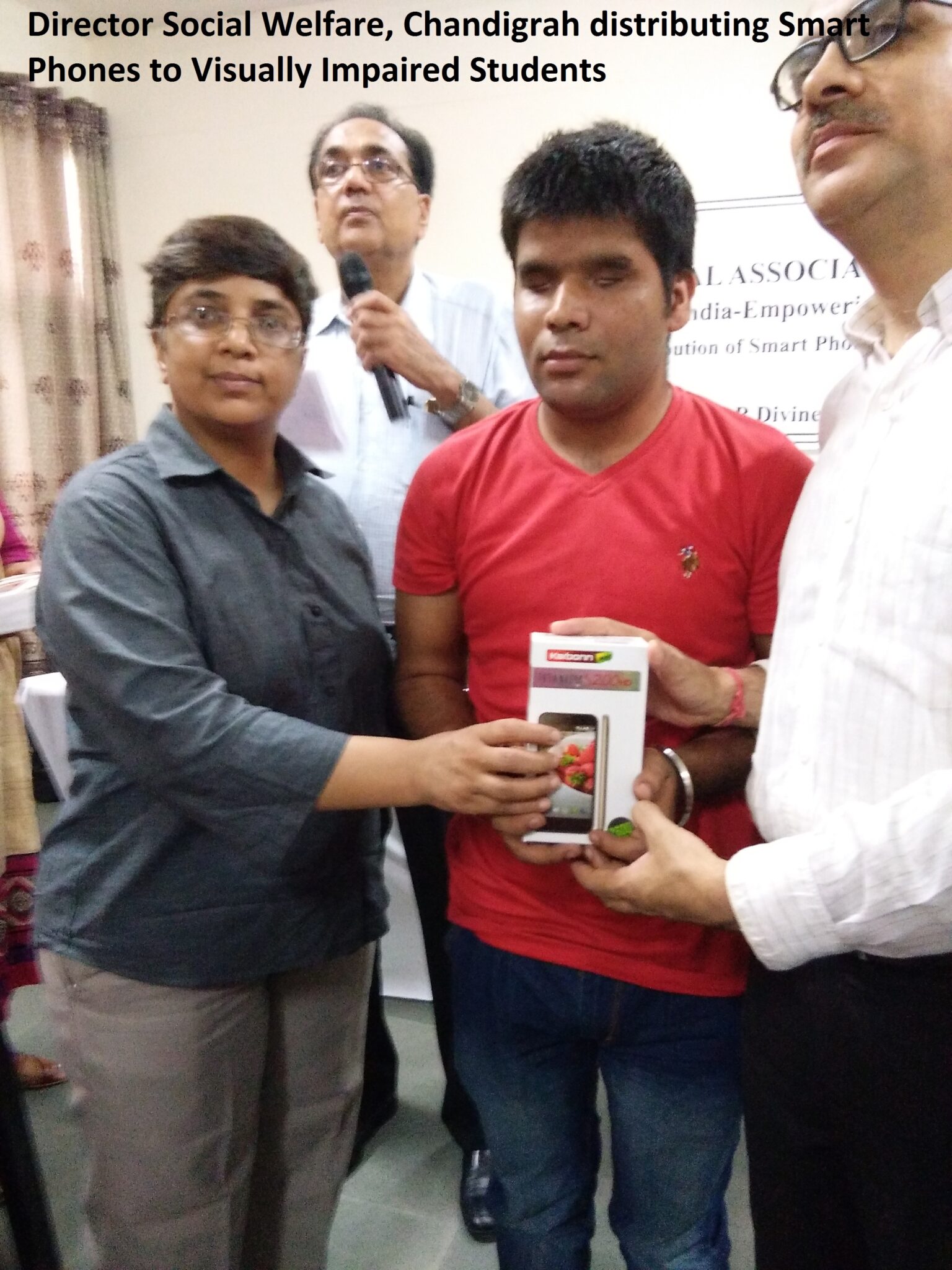 Director Social Chandigarh, distributing smart phones to visually impaired students